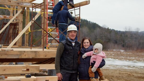 Timberwright Tim Rau with his wife Amanda and daughter Maggie on site at a barn raising in VT.